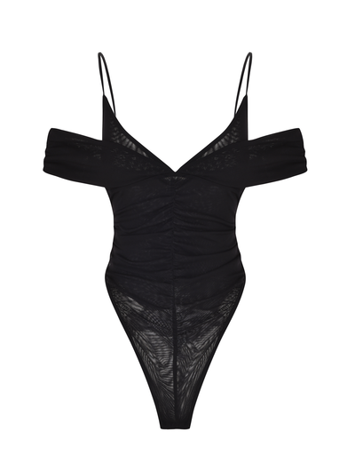 The TIGERMIST DRAYA BODYSUIT in black features an off-shoulder design with thin spaghetti straps, sheer mesh fabric, ruched front, and a bodycon fit with high-cut legs. Displayed on a plain white background.
