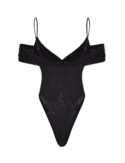 The DRAYA BODYSUIT by TIGERMIST is a black, off-the-shoulder mesh piece with thin spaghetti straps and high-cut legs. Displayed on a white background, its sheer fabric offers a flattering, bodycon fit.