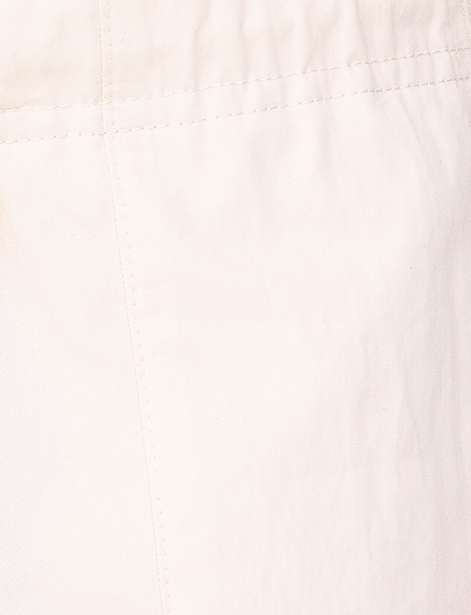 Close-up of TIGERMIST HERMIONE PANT in Soft Butter, showing yellow fabric with visible stitching and seams, highlighting the slightly wrinkled texture.