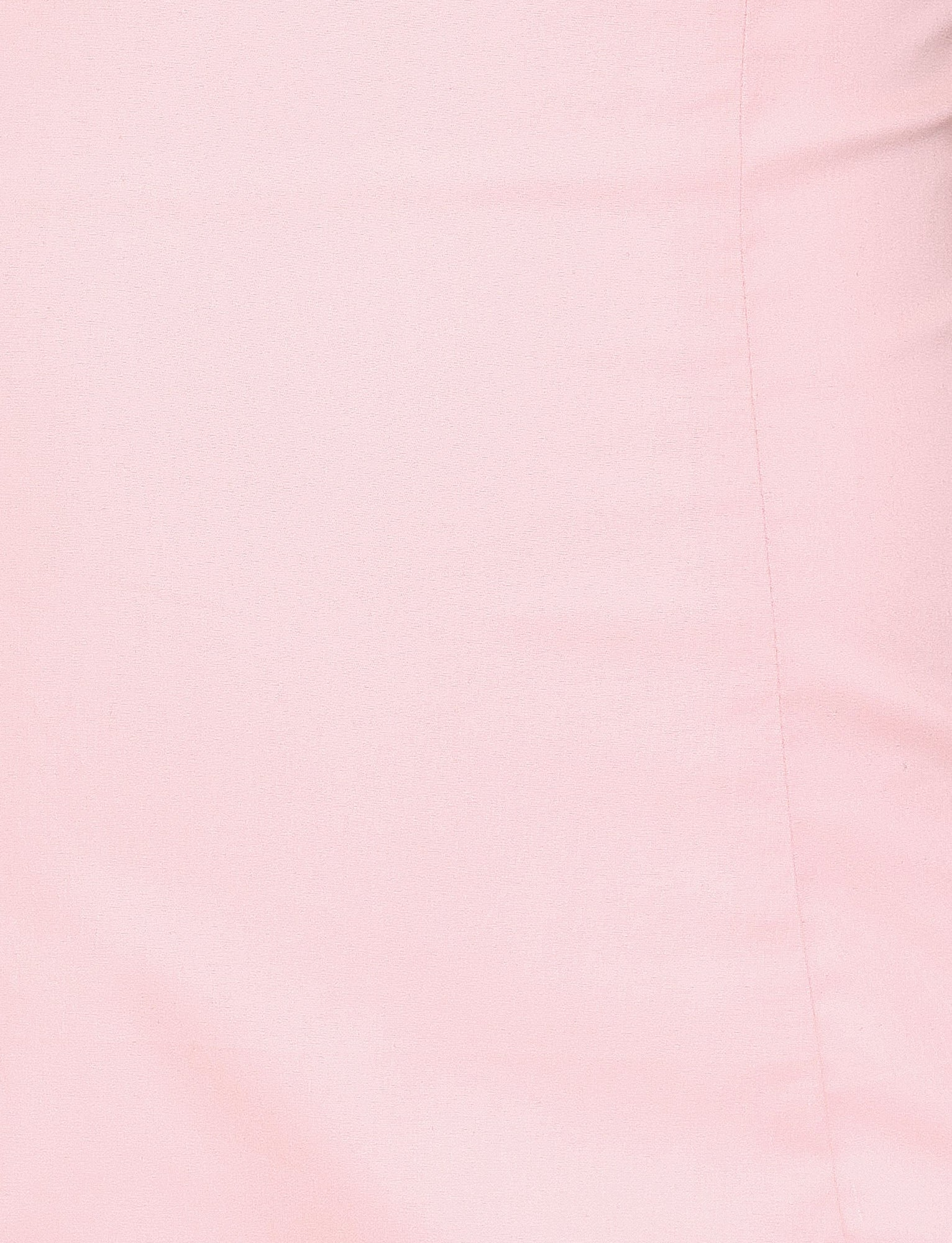 Close-up of the TIGERMIST COLSON MINI DRESS in Baby Pink, showing smooth, light pink fabric with a subtle vertical seam along the right side and a slightly matte texture.