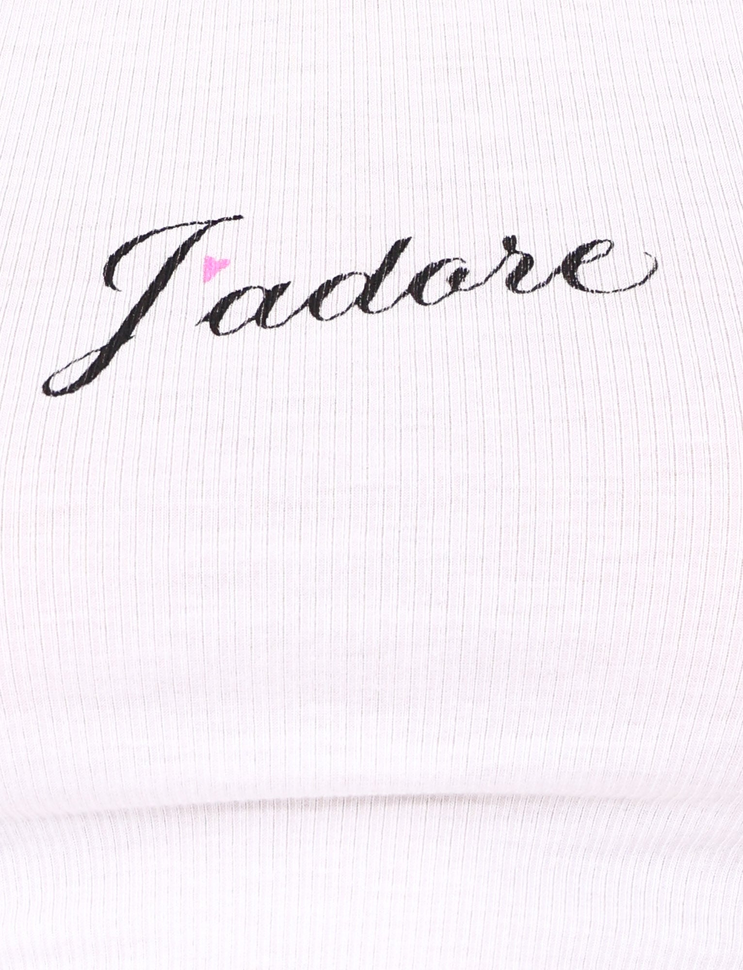 Close-up of the RAFAELLA TANK - WHITE by TIGERMIST, a white ribbed racerback tank top with a black cursive J'Adore graphic and a small pink heart above the "a".