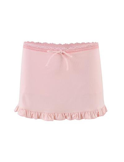 The MIRELLE SKORT - PINK by TIGERMIST is a pastel pink mini skort with a ruffled hem, lace-trimmed waistband, and a front center bow, shown on a white background.