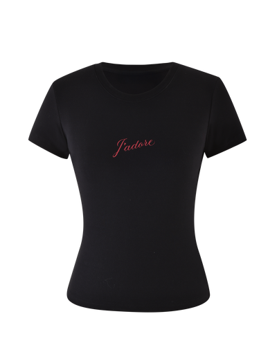 The SAPHIRA TEE - BLACK by TIGERMIST is a fitted black tee crafted from high-stretch fabric, with a bold red cursive J'Adore graphic across the chest.