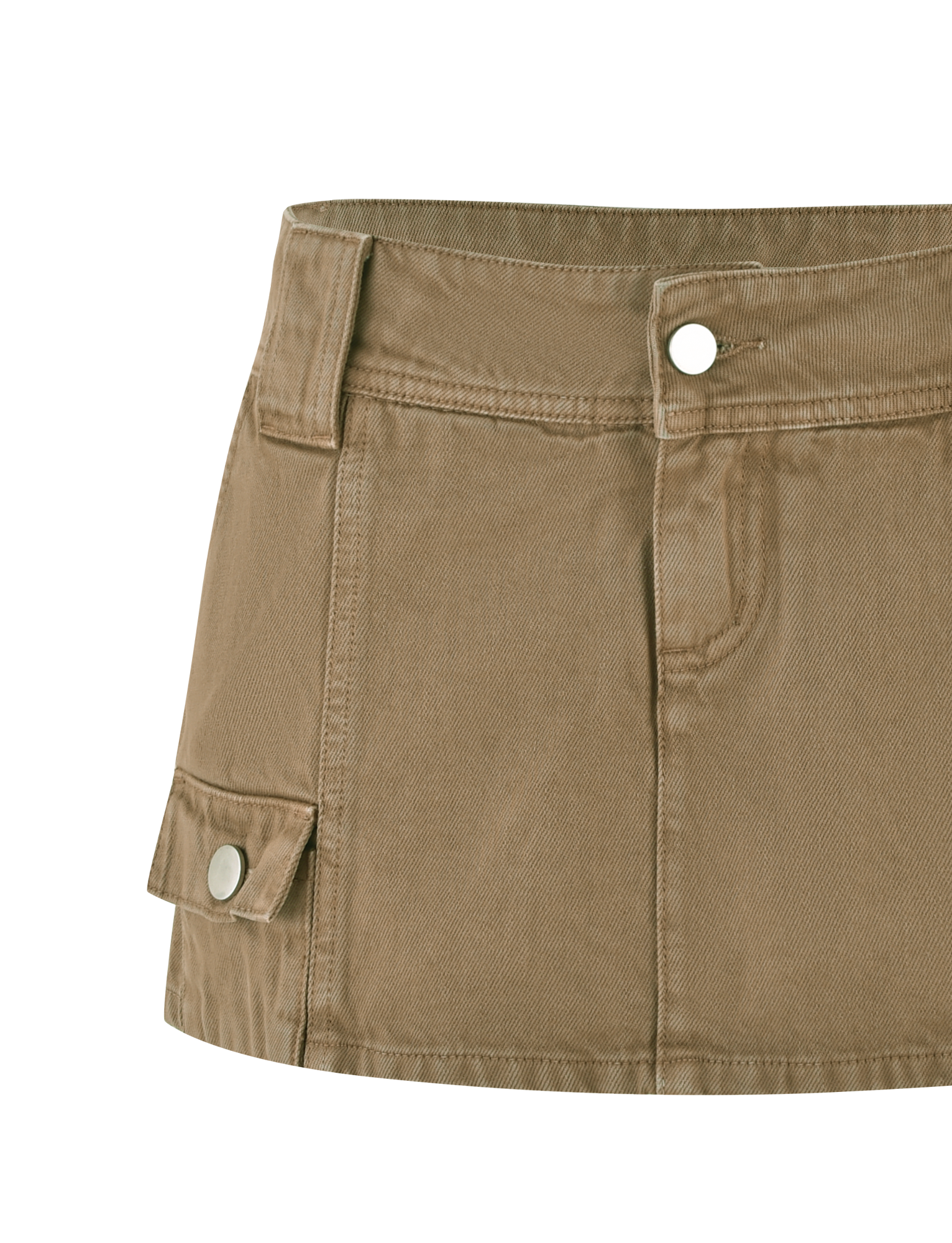 A close-up of the TIGERMIST ZELIE MINI SKORT in washed tan sandblast shows a utility design with front button and zipper, waistband with belt loops, detailed stitching, and a functional side flap pocket with snap button.