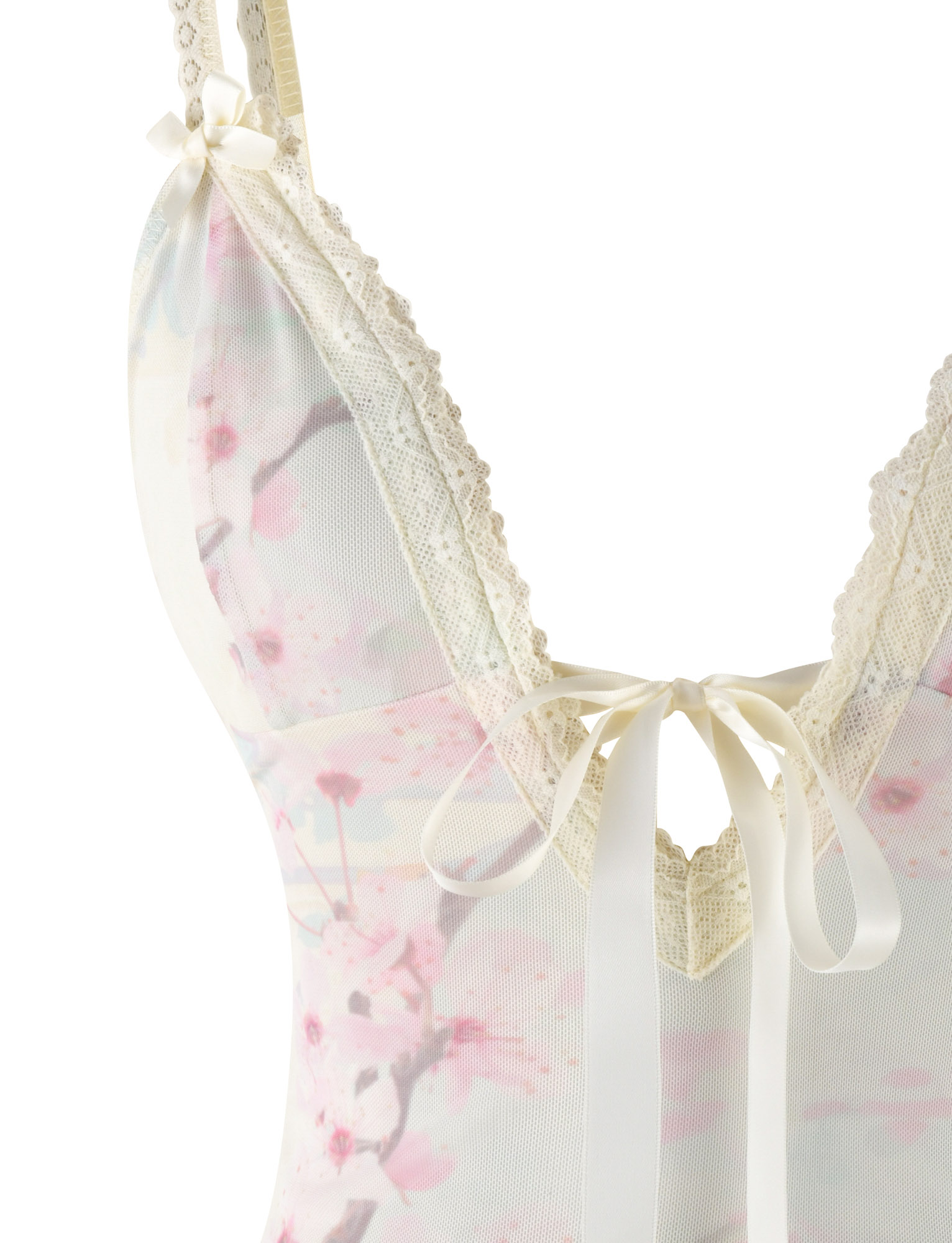 Close-up of the TIGERMIST LONIE TOP in Washed Cherry Blossom—floral print, lace trim, cream ribbon bows at the straps and neckline, with soft pink and ivory tones for a delicate look.