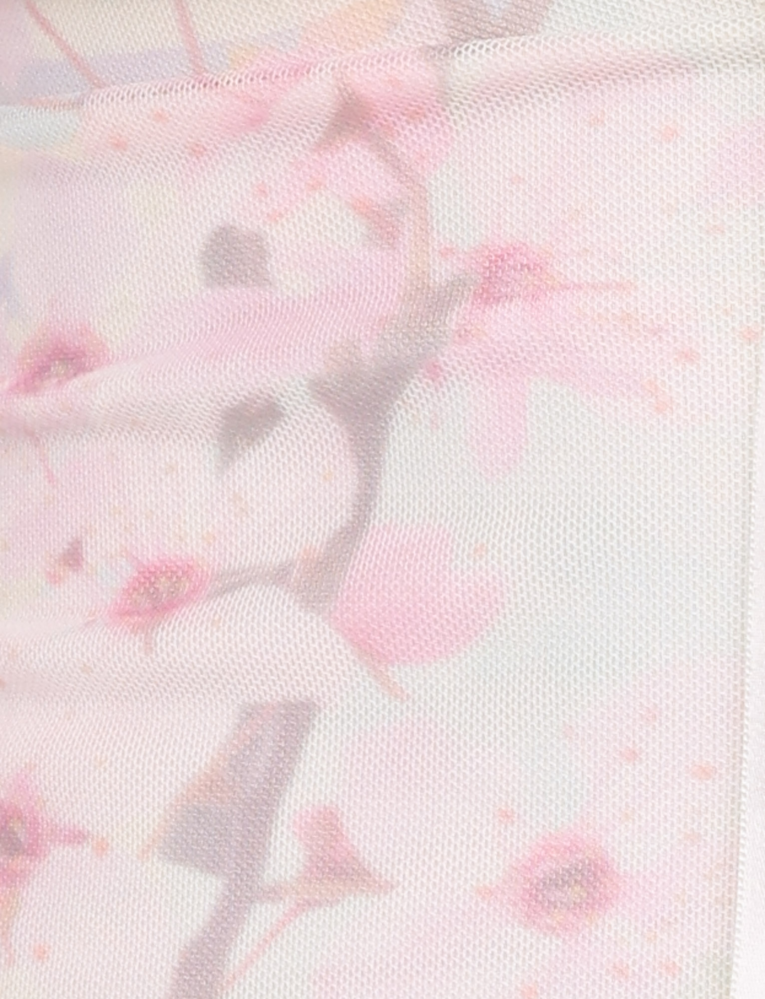 Close-up of the LONIE TOP by TIGERMIST in Washed Cherry Blossom, showcasing sheer, light pink fabric with a delicate floral print of soft pink cherry blossoms and subtle branches. The texture is slightly textured and translucent.