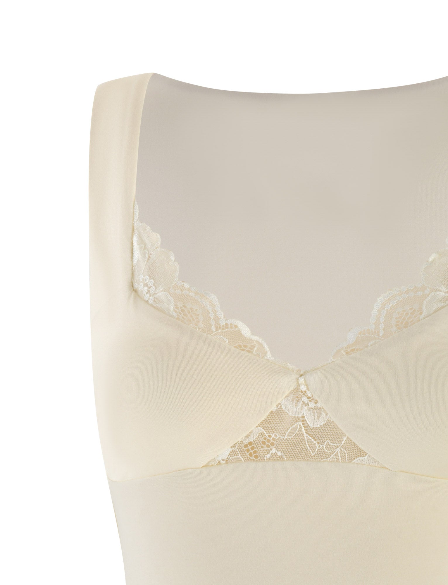 A close-up of the DIONE LACE TOP by TIGERMIST in Soft Butter showcases its seamless, cream-colored jersey fabric with wide straps and delicate lace trim enhancing the neckline, offering a simple yet elegant appearance.