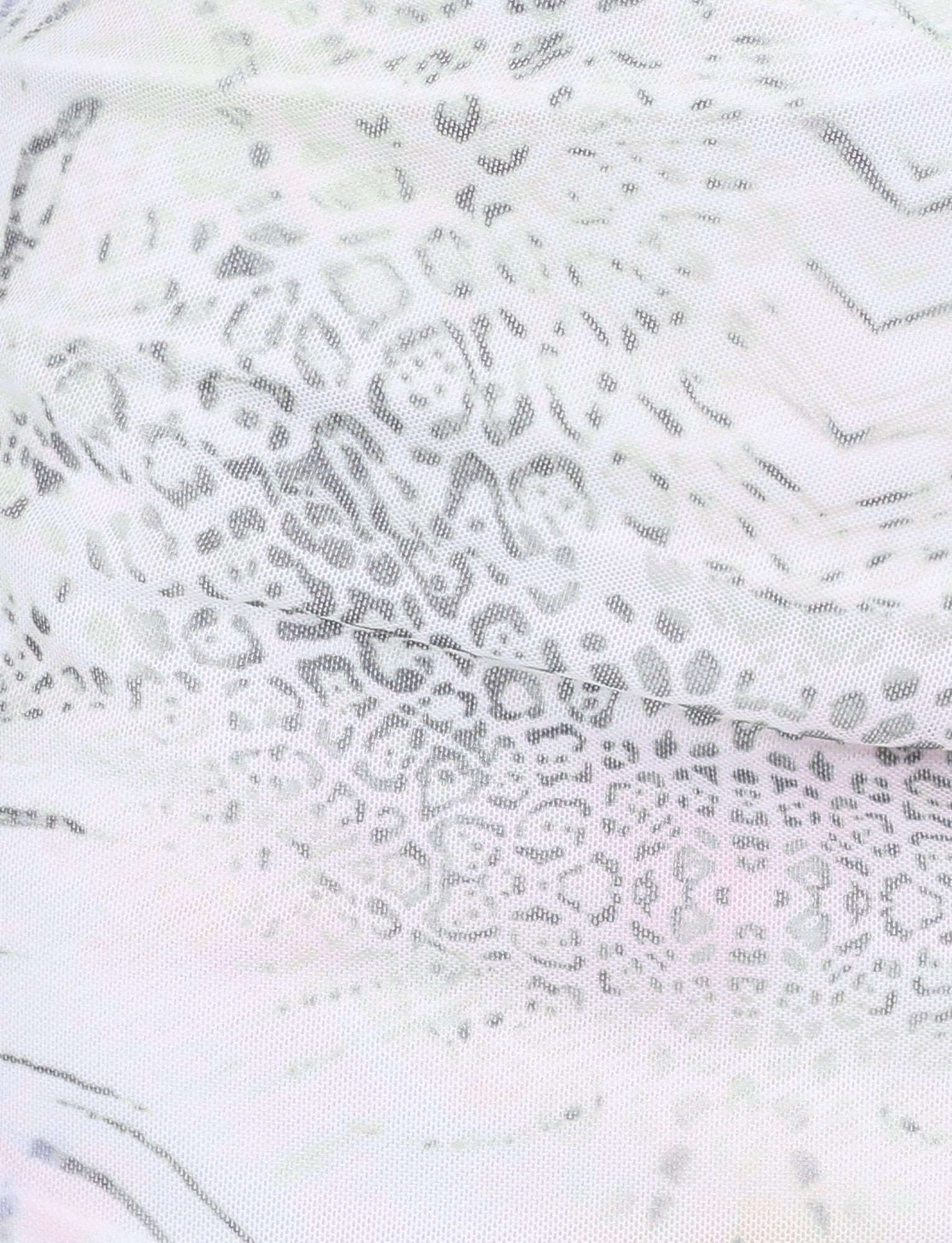 Close-up of the TIGERMIST JOSEPHINE MINI SKIRT in white animal print, featuring light semi-transparent fabric with a subtle leopard pattern—perfect for trendy mesh mini skirt styles or ruched side seam designs.