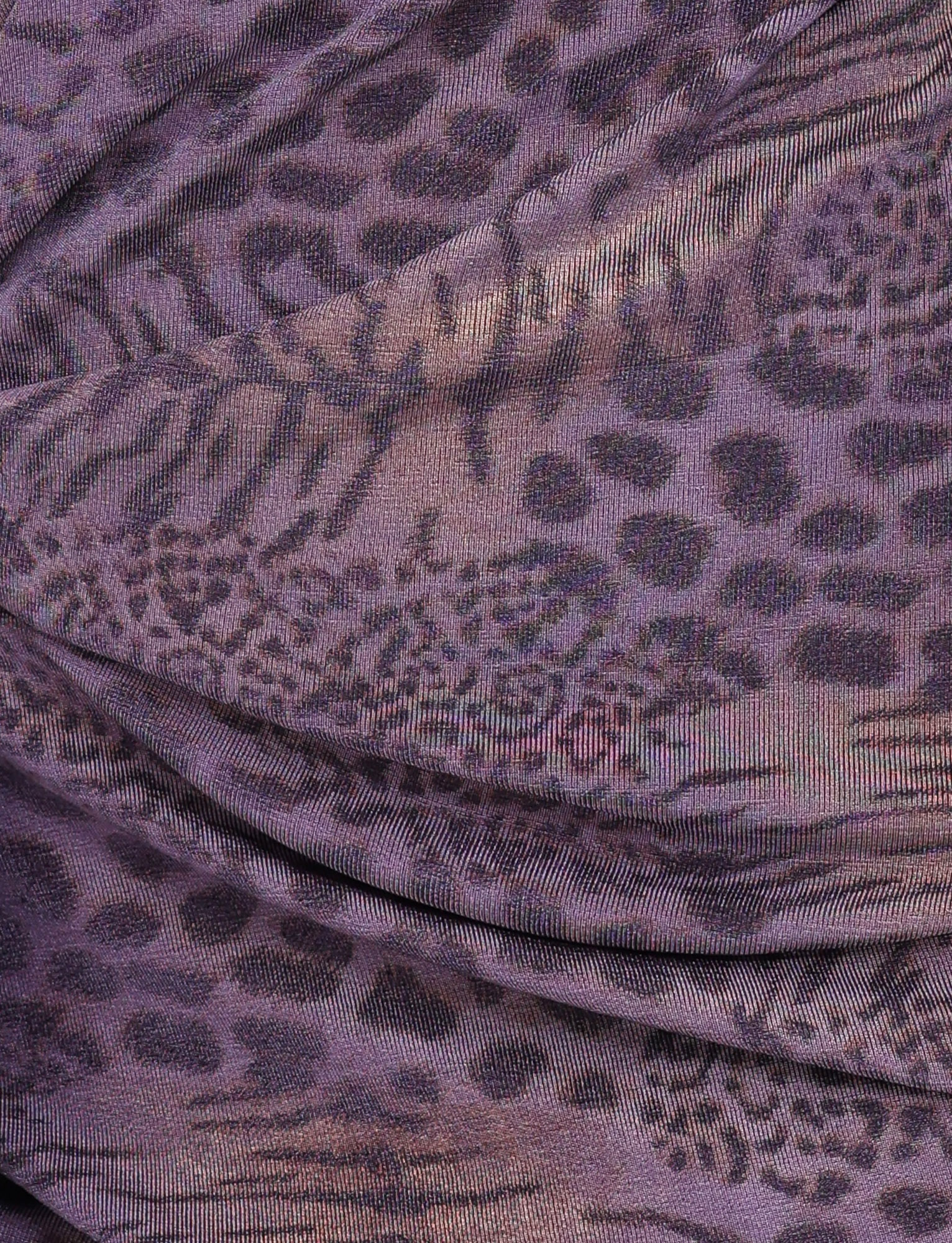 Close-up of the INDIGO MINI DRESS - PURPLE TIGER by TIGERMIST, featuring purple and black tiger print fabric with textured folds—ideal for a standout mini dress with a V wrap neckline.