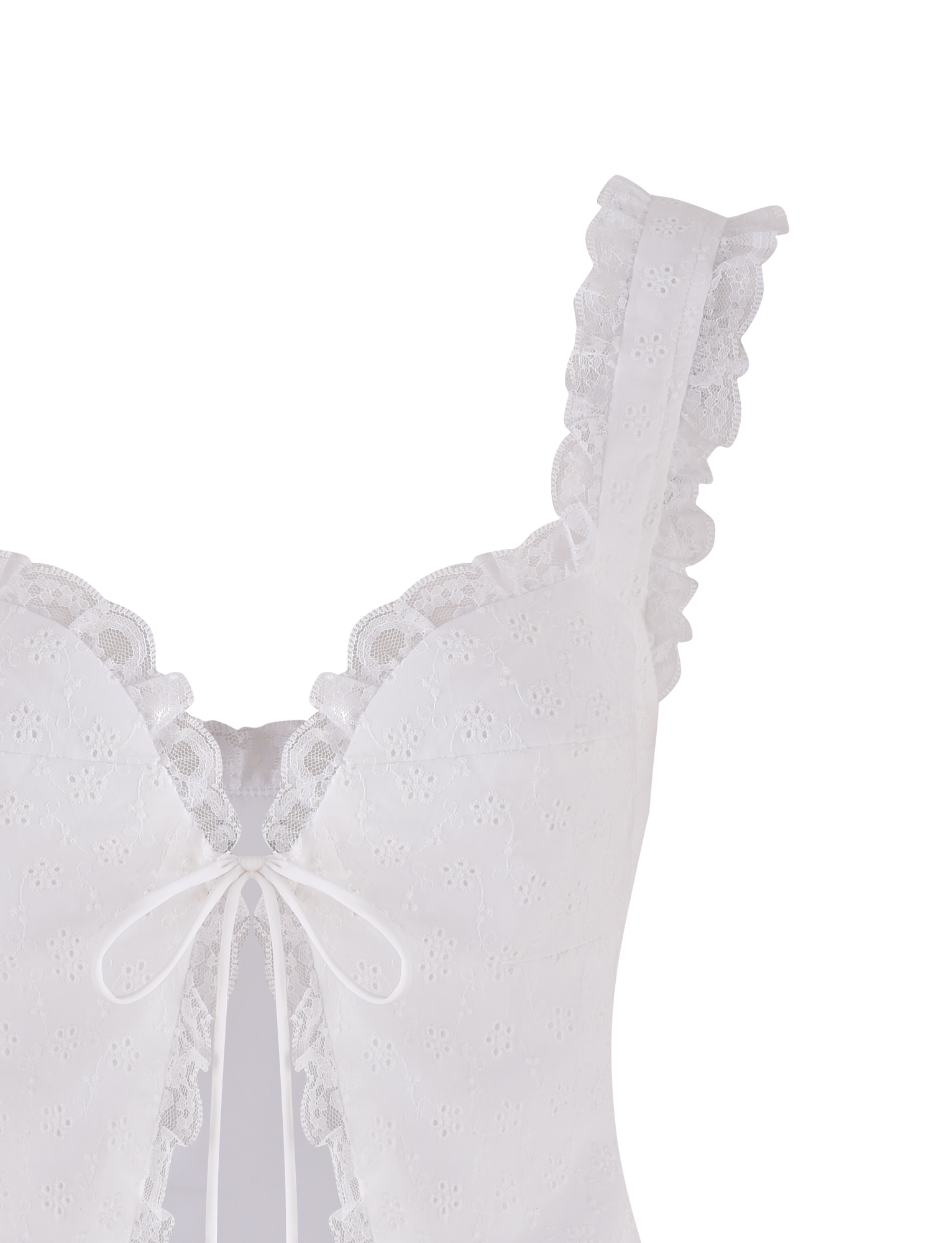 The KYANA TOP - WHITE by TIGERMIST is a cropped camisole featuring thin straps, scalloped lace trim, a front bow, and embroidered floral eyelets for a delicate, feminine look.