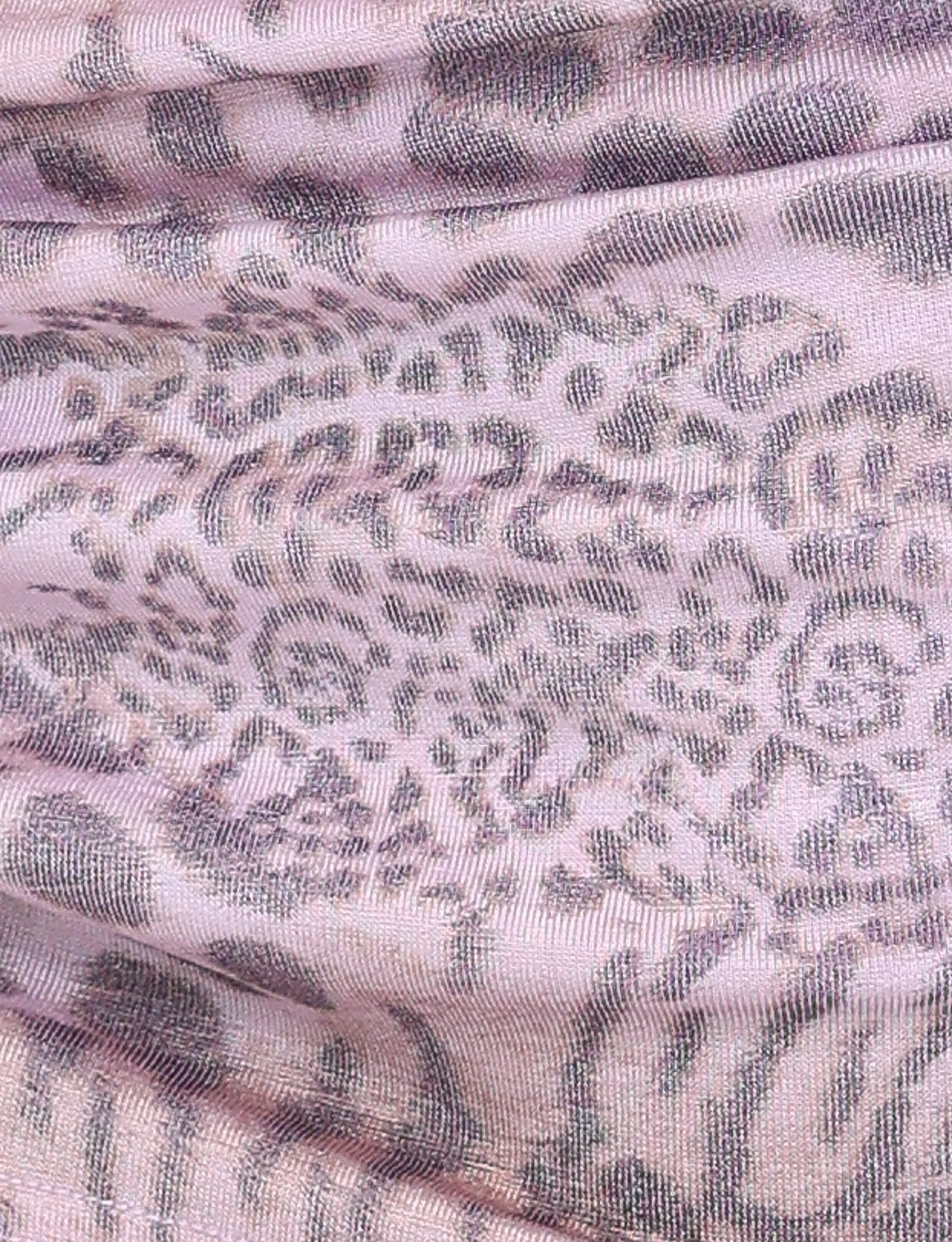 Close-up of the EVANGELINE SKIRT - PINK : TIGER by TIGERMIST, featuring pale pink fabric with a textured gray and purple tiger print—slightly sheer with soft folds, perfect for adding a trendy twist to your look.