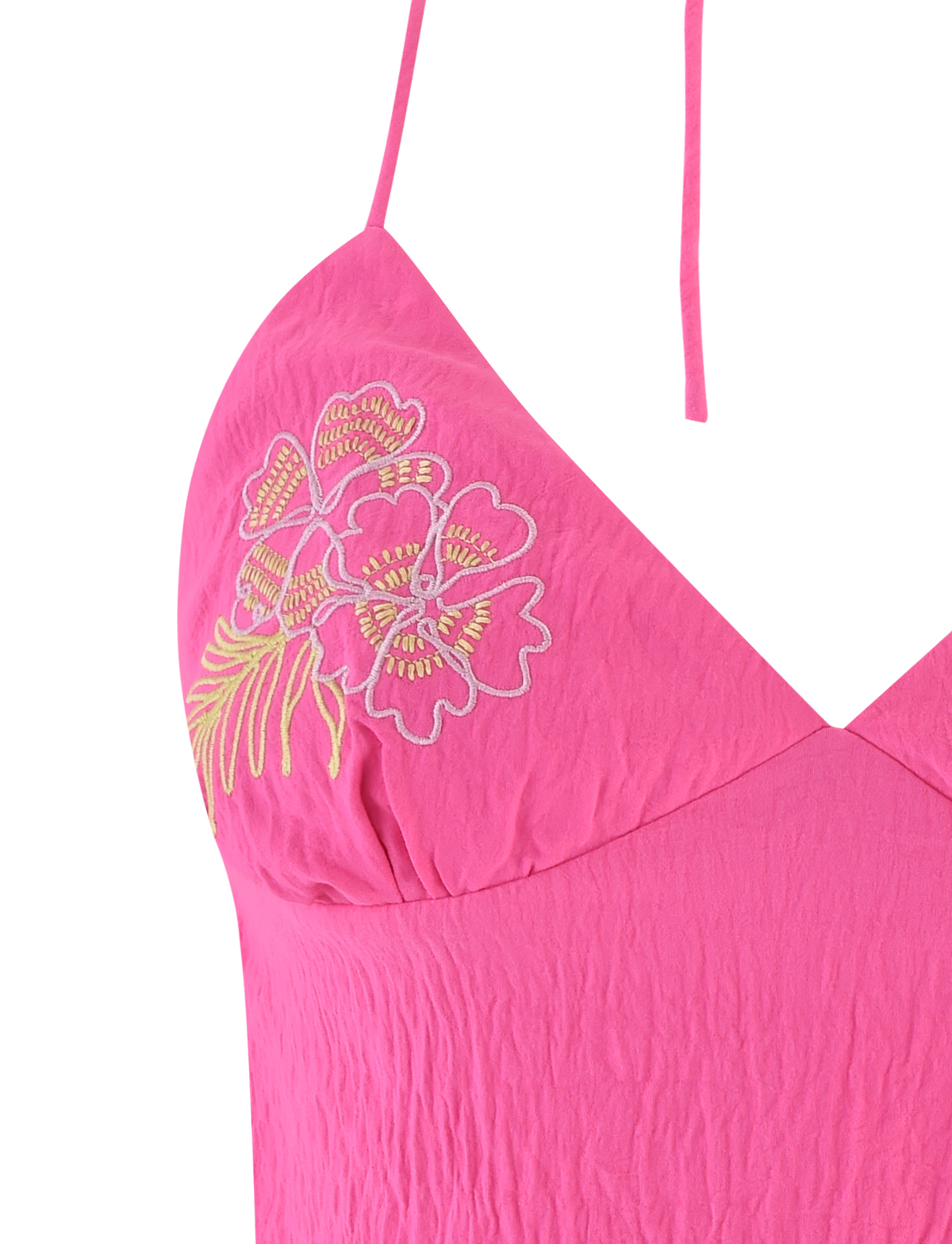 Close-up of the TIGERMIST KAELAH TOP in hot pink, a halter style with a V-neckline, spaghetti straps, and yellow and white floral embroidery on the left chest.
