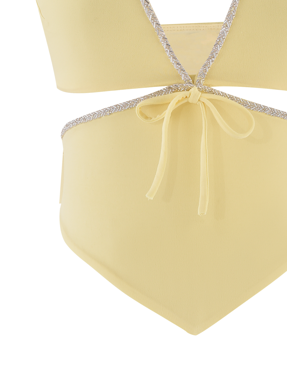 A close-up of the TIGERMIST LIZZIE TOP - LEMON, a pale yellow swimsuit top with silver trim, crisscross design, cut-out details, and a bow tie at the waist.