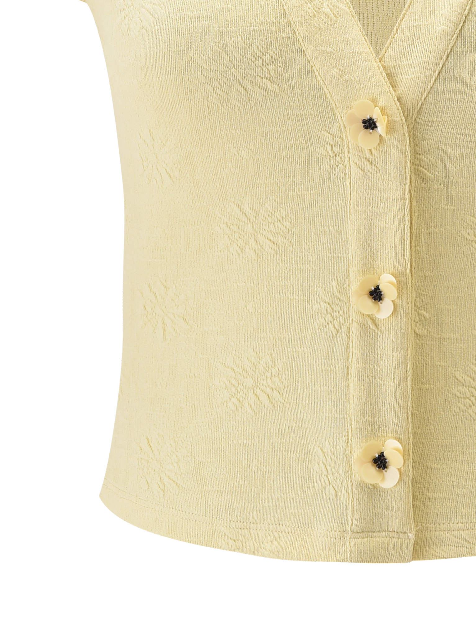 The QUINLAN TOP - LEMON by TIGERMIST is a light yellow textured knit with cap sleeves, a V-neckline, subtle pattern, and three flower-shaped buttons with black centers along the front.