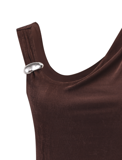 A close-up of the TIGERMIST CASSIAN TOP - CHOCOLATE, a velvet tank top with a silver oval-shaped decorative pin near the left shoulder.