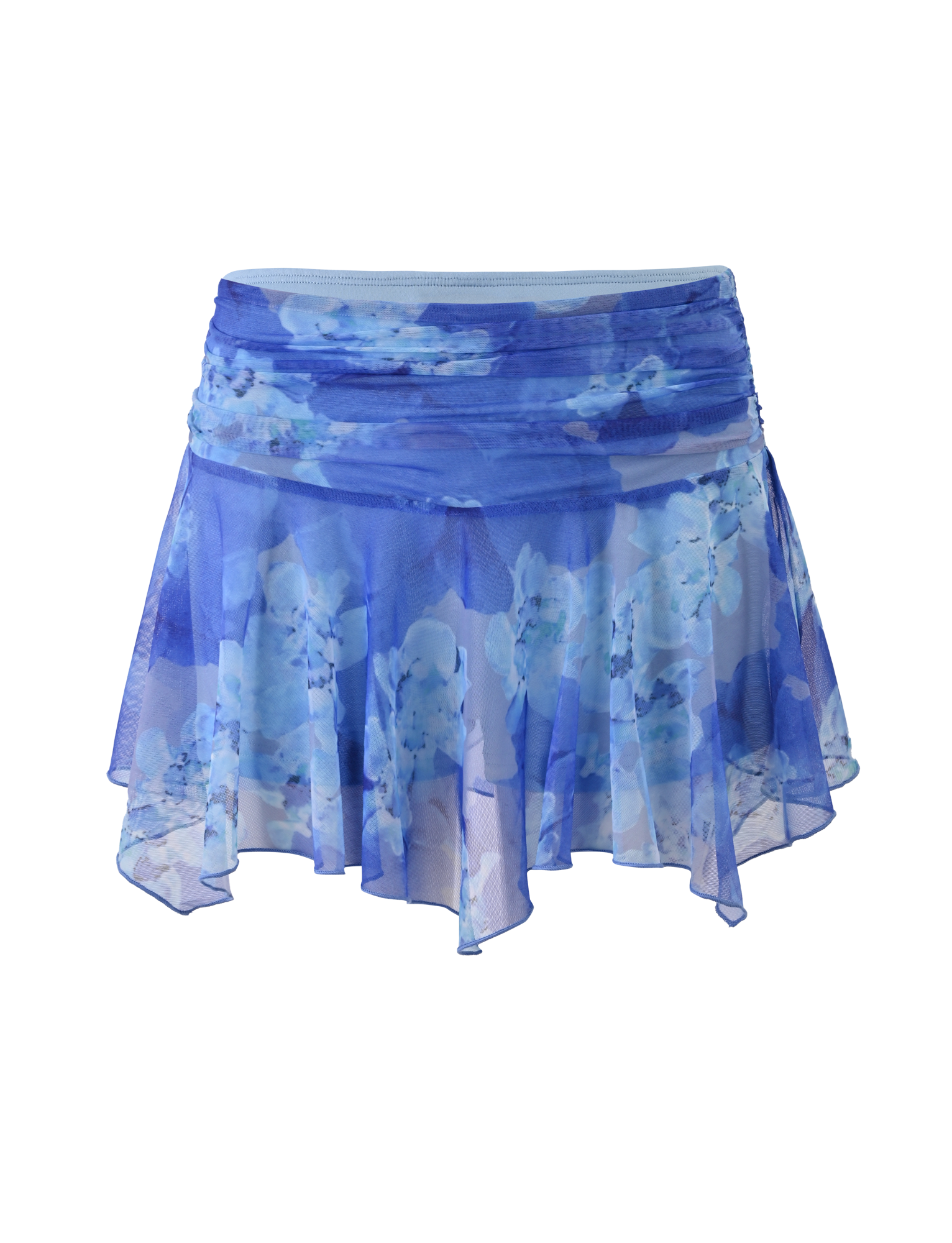 The DEVYN MINI SKORT by TIGERMIST features a flowy, sheer blue macro floral print, an asymmetrical handkerchief hemline, layered details, and a ruched waistband for a dreamy mid rise mini look.