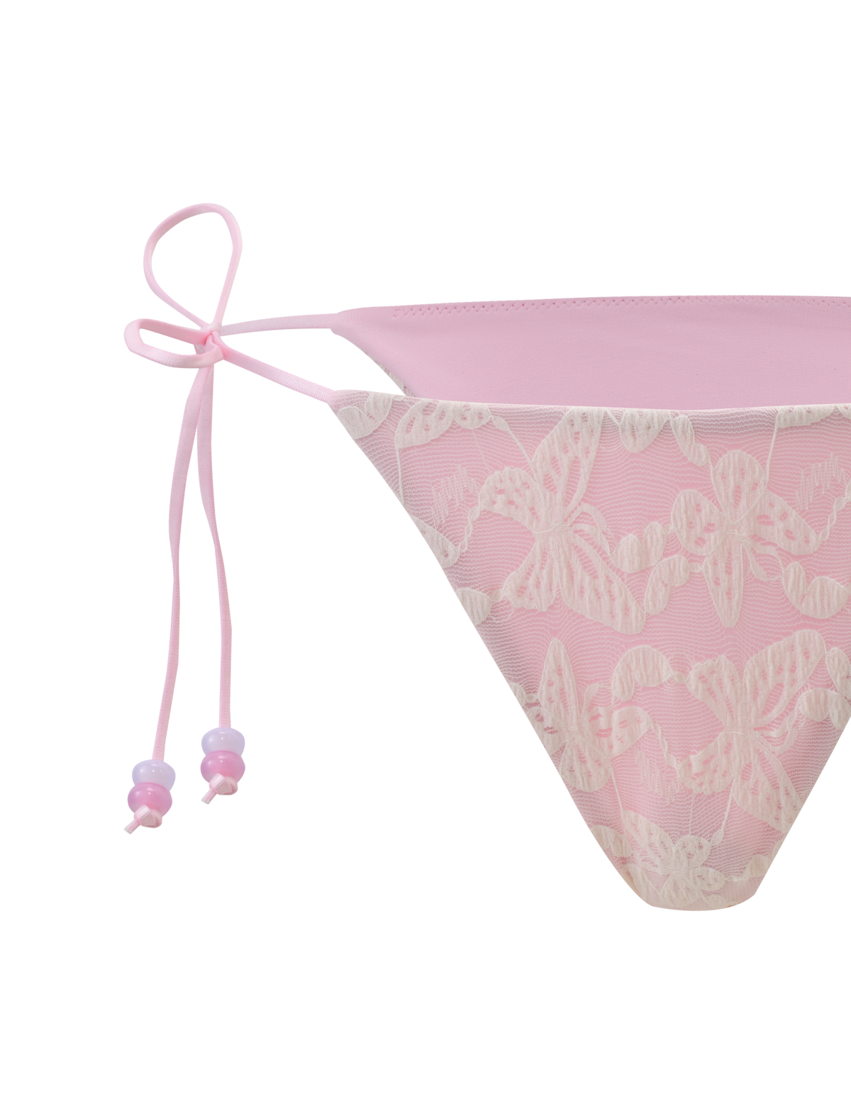The TIGERMIST BRIGITTE BIKINI BOTTOM in ivory lace features butterfly patterns, thin side ties, and a cheeky cut, shown close-up against a light background.