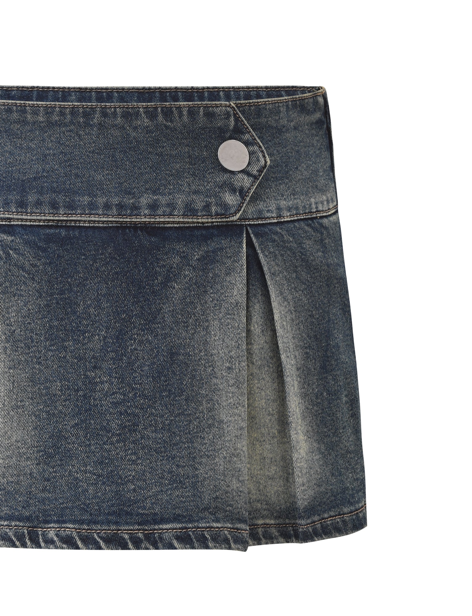 The TIGERMIST LUPITA SKORT - MID WASH is a pleated denim mini skort with a wide waistband, silver snap button, front pleat detail, and built-in shorts for comfort.