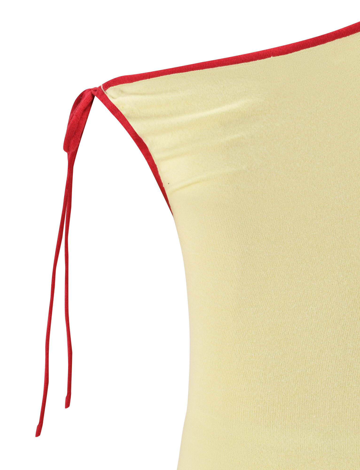 Close-up of the TIGERMIST ALIRA TOP in yellow, featuring an off-shoulder design with a red strap tied in a bow and a red contrast neckline. The blurred background complements the top with matching red and beige tones.