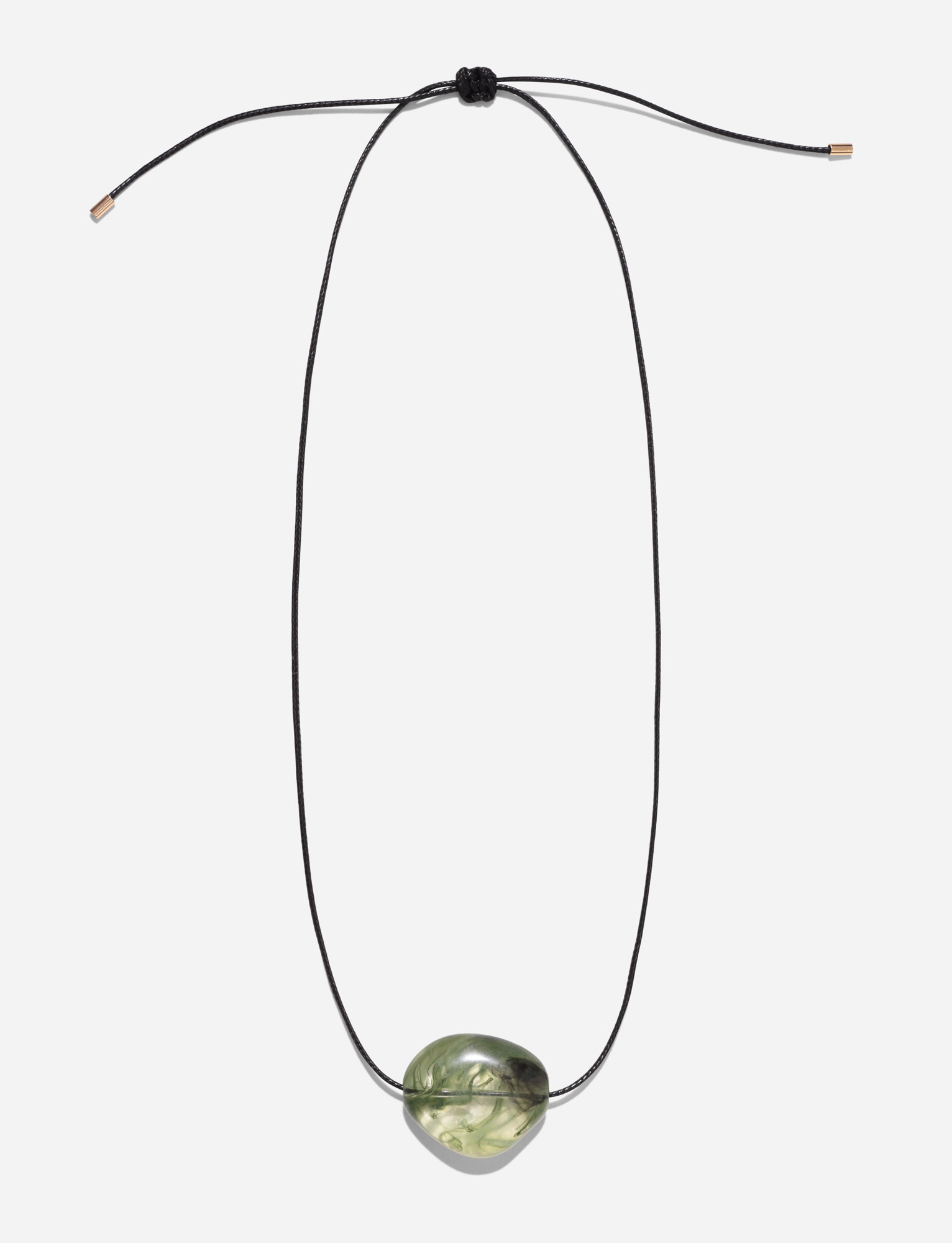 The SOLENE NECKLACE - GREEN by TIGERMIST features a black woven adjustable cord and a single polished green stone pendant, shown against a plain white background.
