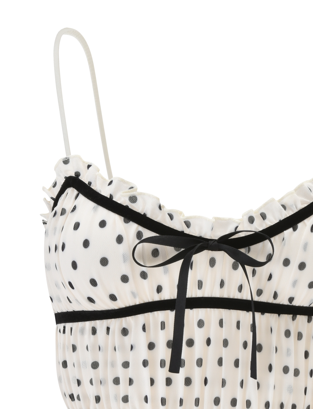 Close-up of the TIGERMIST LIORA TOP - POLKA DOT, featuring a white sheer fabric with polka dots, ruffled trim, thin adjustable straps, and a small black ribbon bow at the neckline.
