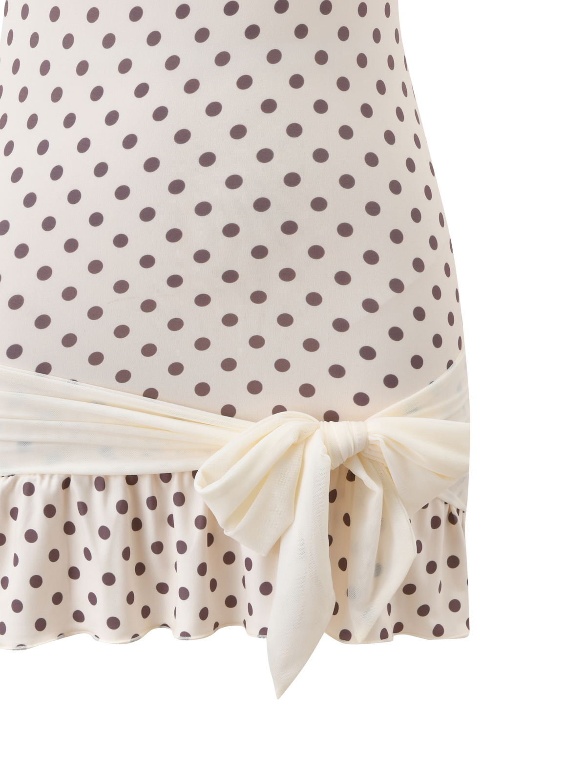 Close-up of the TIGERMIST TOVE MINI DRESS in white polka dot, showcasing its strapless design, wide sash at the waist, and playful ruffle hem.