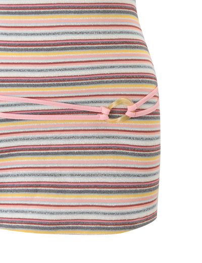 Close-up of the TIGERMIST CELESTE MINI DRESS - MULTISTRIPE, featuring yellow, pink, white, and gray stripes with a side circular cutout tied with pink string.