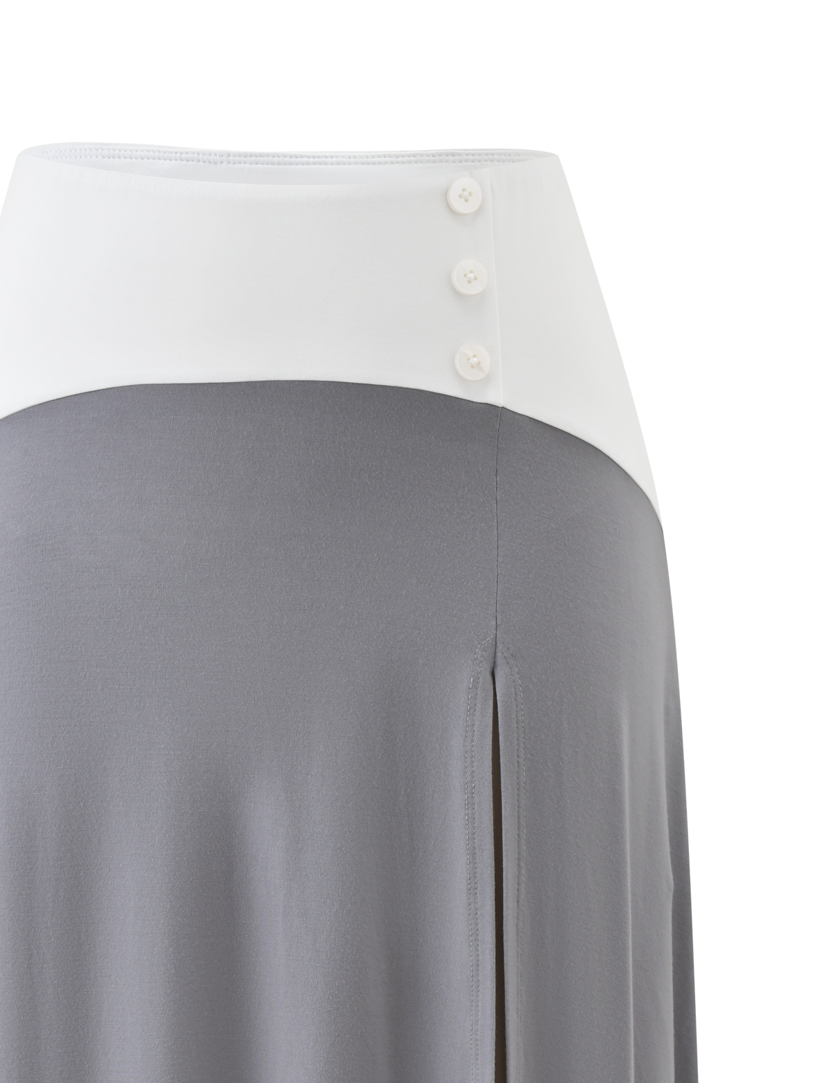 The ALYSSA HI LO SKIRT - GREY by TIGERMIST features a white high waistband with three buttons, a grey flowing lower section, an asymmetrical hem, and a front leg slit.