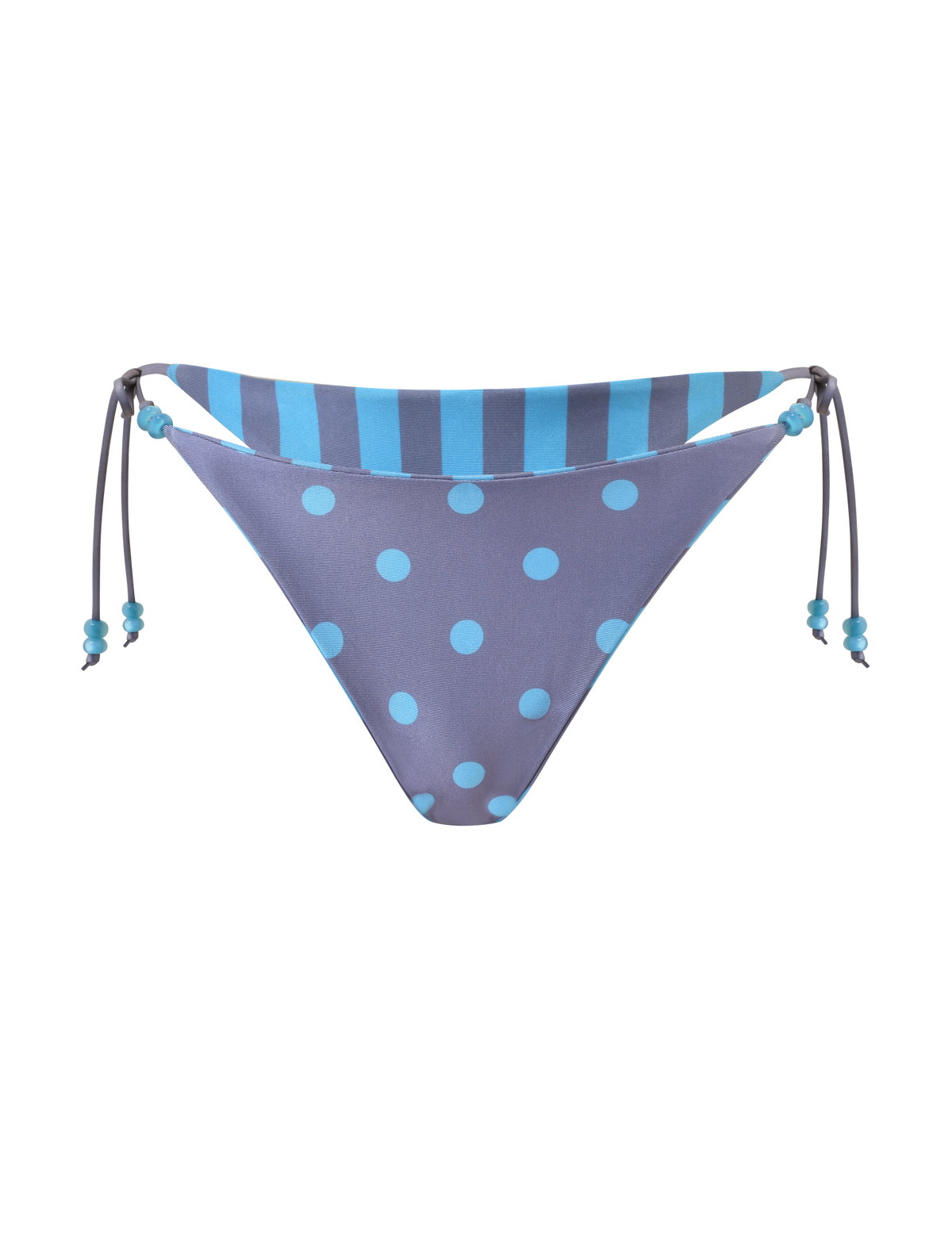The FINLEA REVERSIBLE BIKINI BOTTOM by TIGERMIST features blue polka dots on purple, a blue and navy striped waistband, adjustable side ties with blue beads, beaded accents, and a cheeky cut.