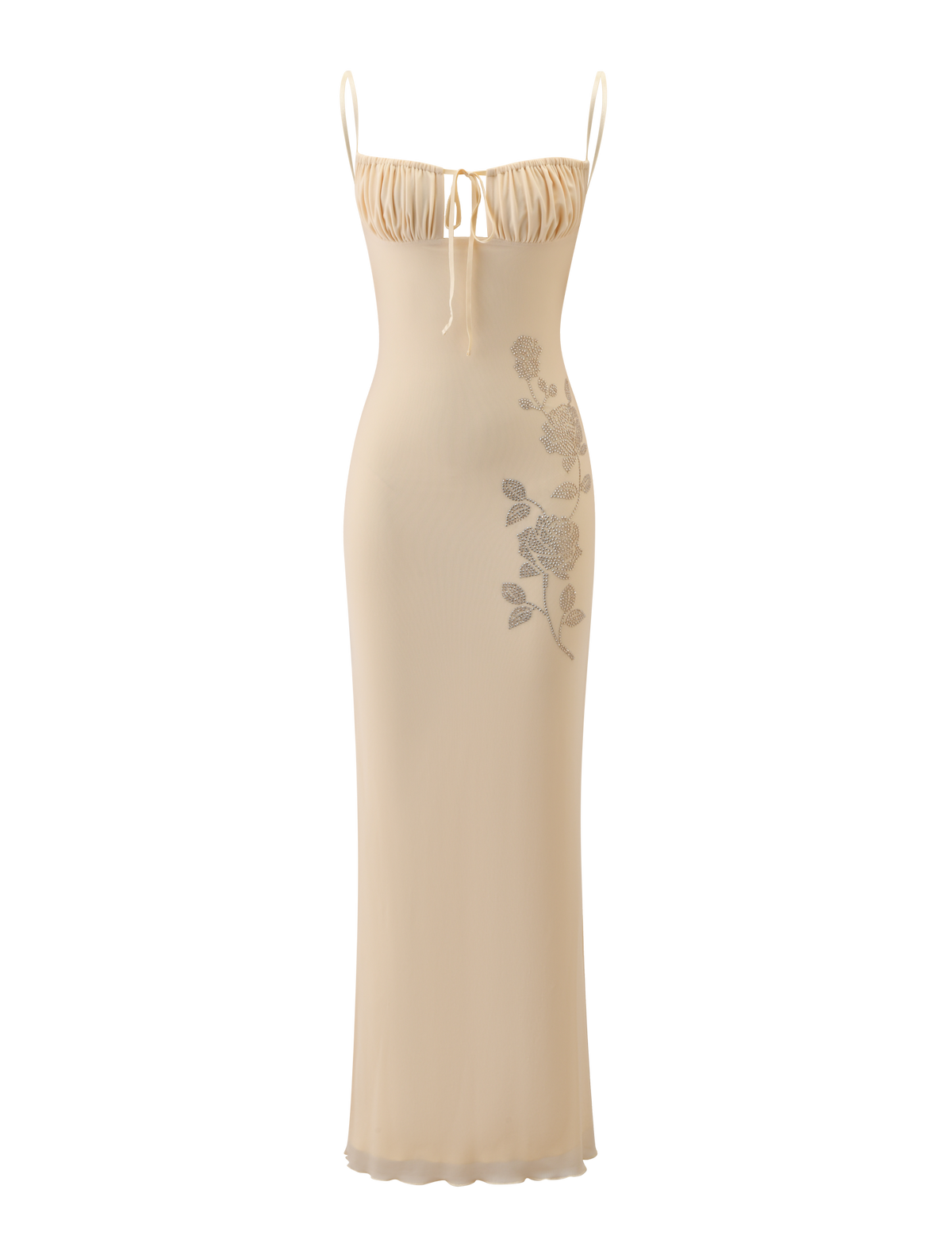 The OPHELIA MAXI DRESS - CREAM by TIGERMIST is a long, fitted slip dress with adjustable spaghetti straps, a ruched bust with tie detail, and subtle floral embellishment on the left side.