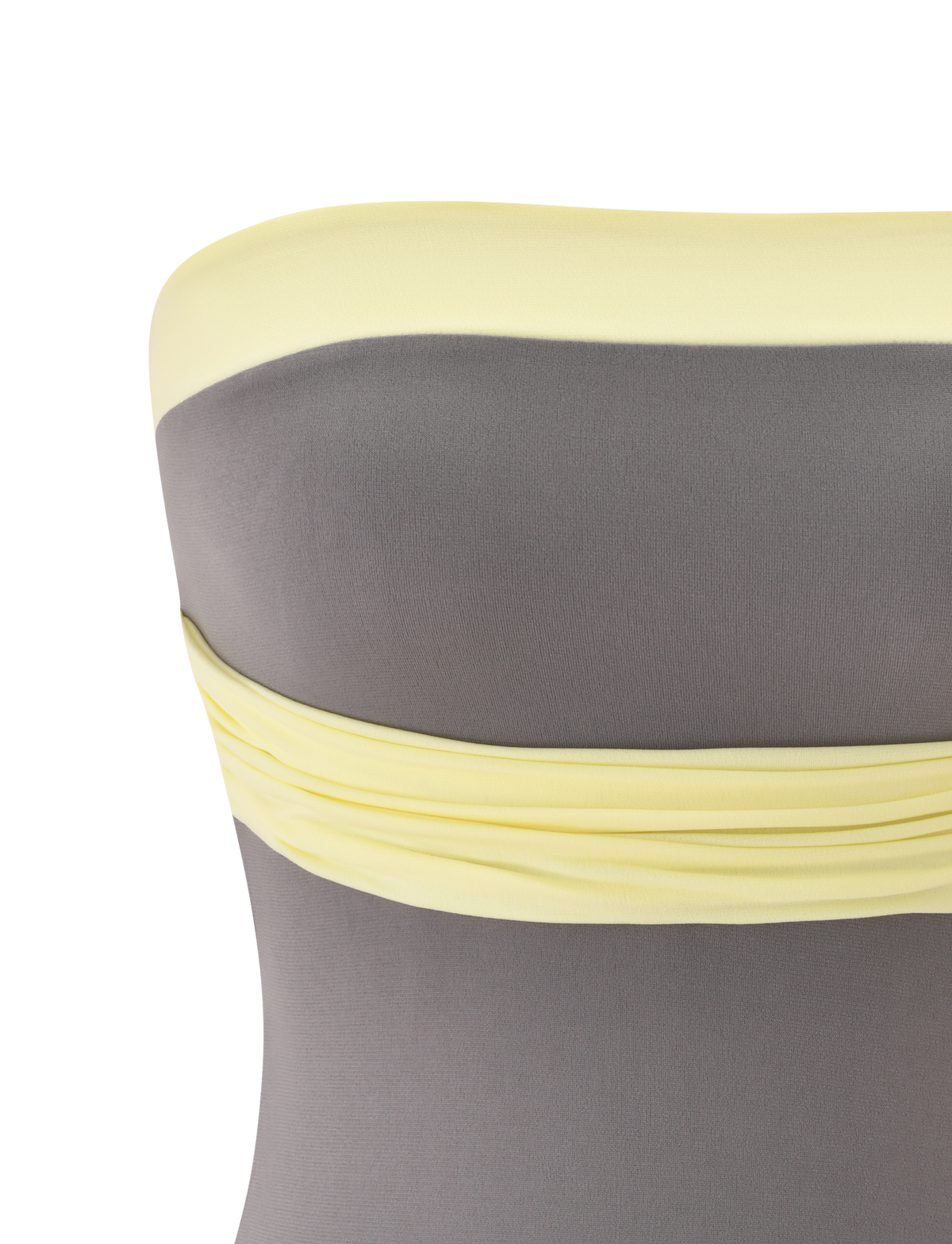 A close-up of the TIGERMIST EOS TOP - GREY AND YELLOW shows a strapless neckline, grey body, pale yellow trim, and gathered detailing along the top edge on a white background.