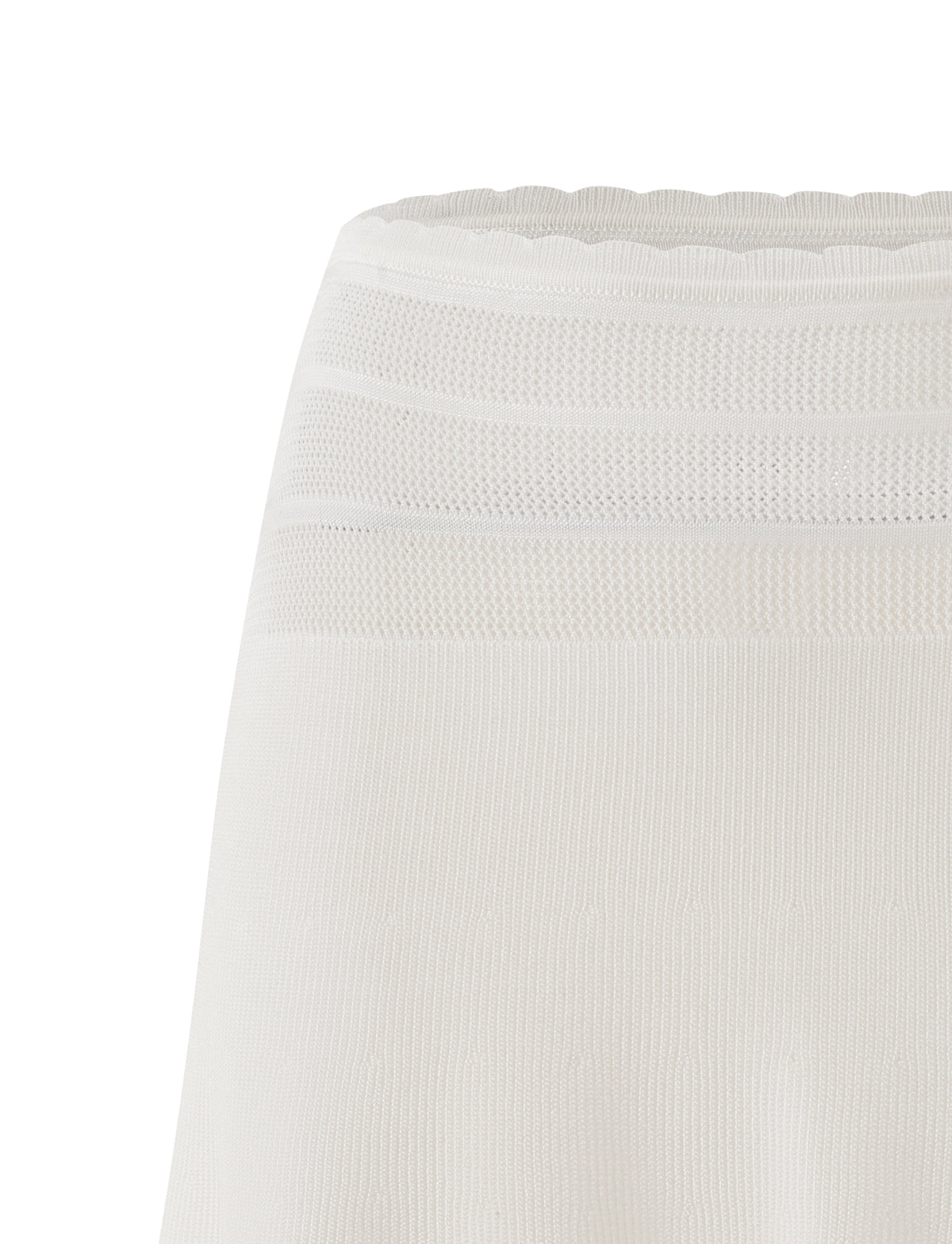 A close-up of the TIGERMIST DENI MINI SKIRT in cream highlights its white textured fabric with mesh and ribbed patterns near the waistband, showcasing the subtle elegance characteristic of this stylish mini skirt.