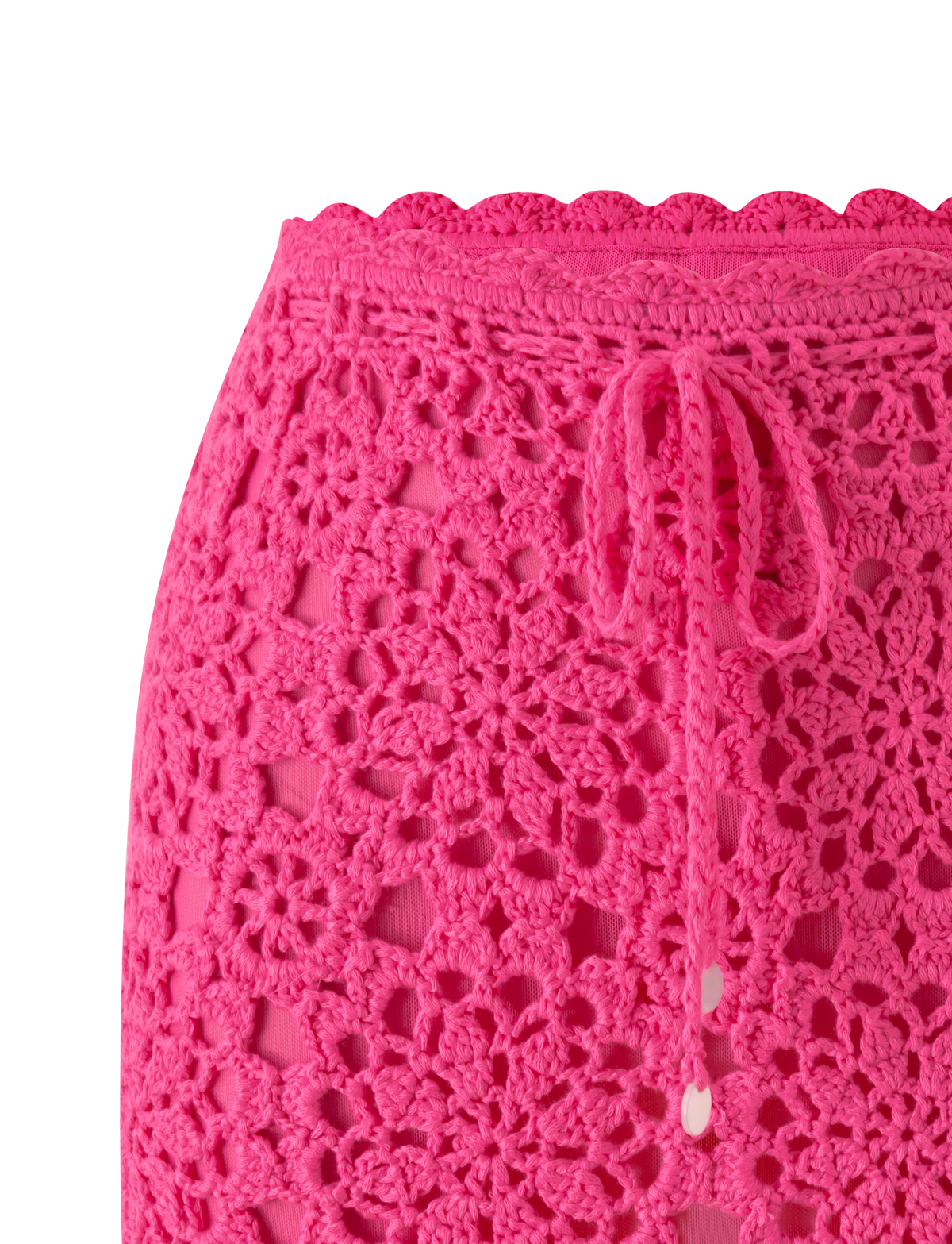 Close-up of the SASHA CROCHET MINI SKIRT - HOT PINK by TIGERMIST, featuring a floral pattern, scalloped waistband, and drawstring tie—perfect as a unique crochet vacation skirt.