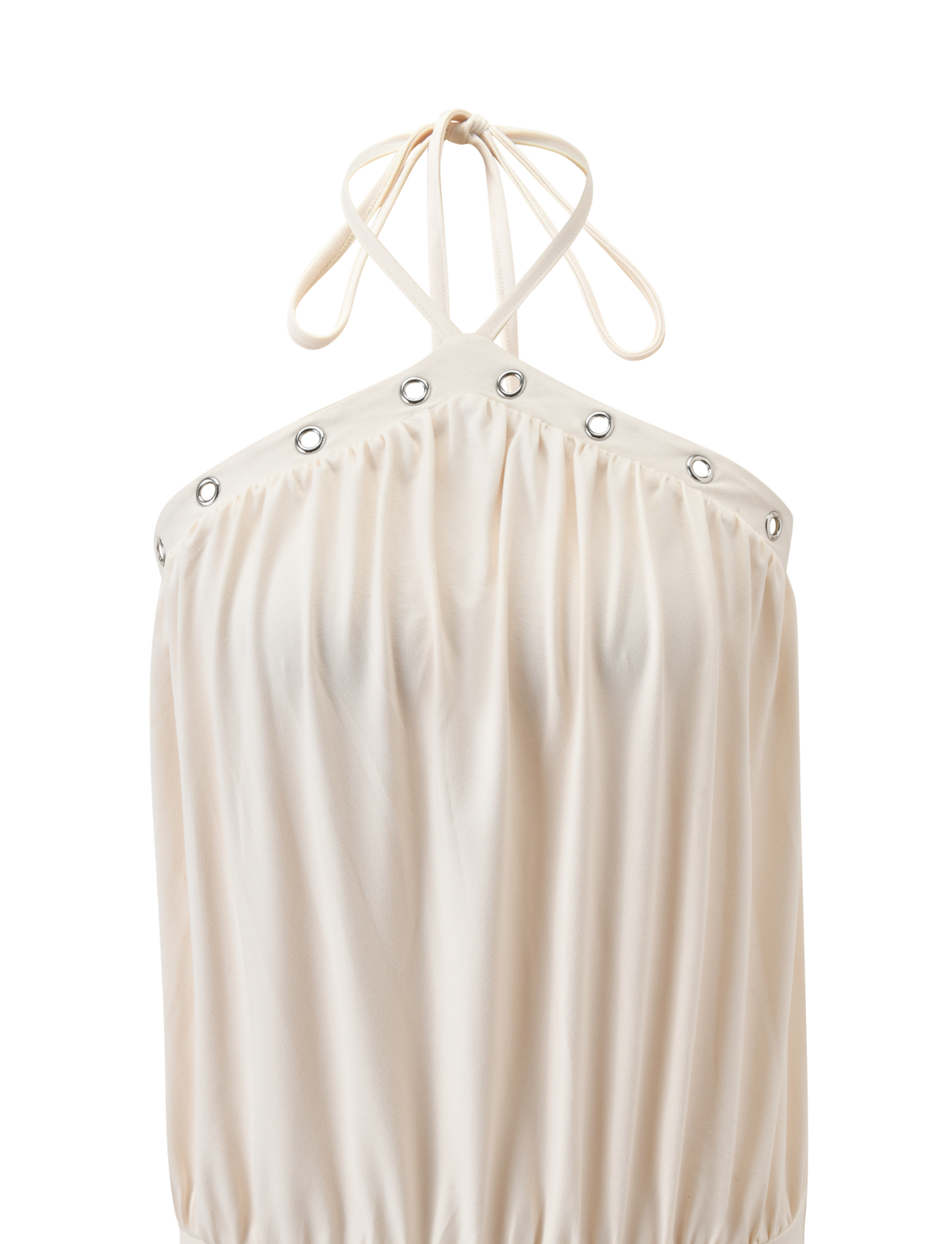 The NATASHA DRESS - CREAM by TIGERMIST features a halter neckline with thin tie straps, silver grommet accents along the top edge, a gathered flowing texture, and a stylish bubble hem.