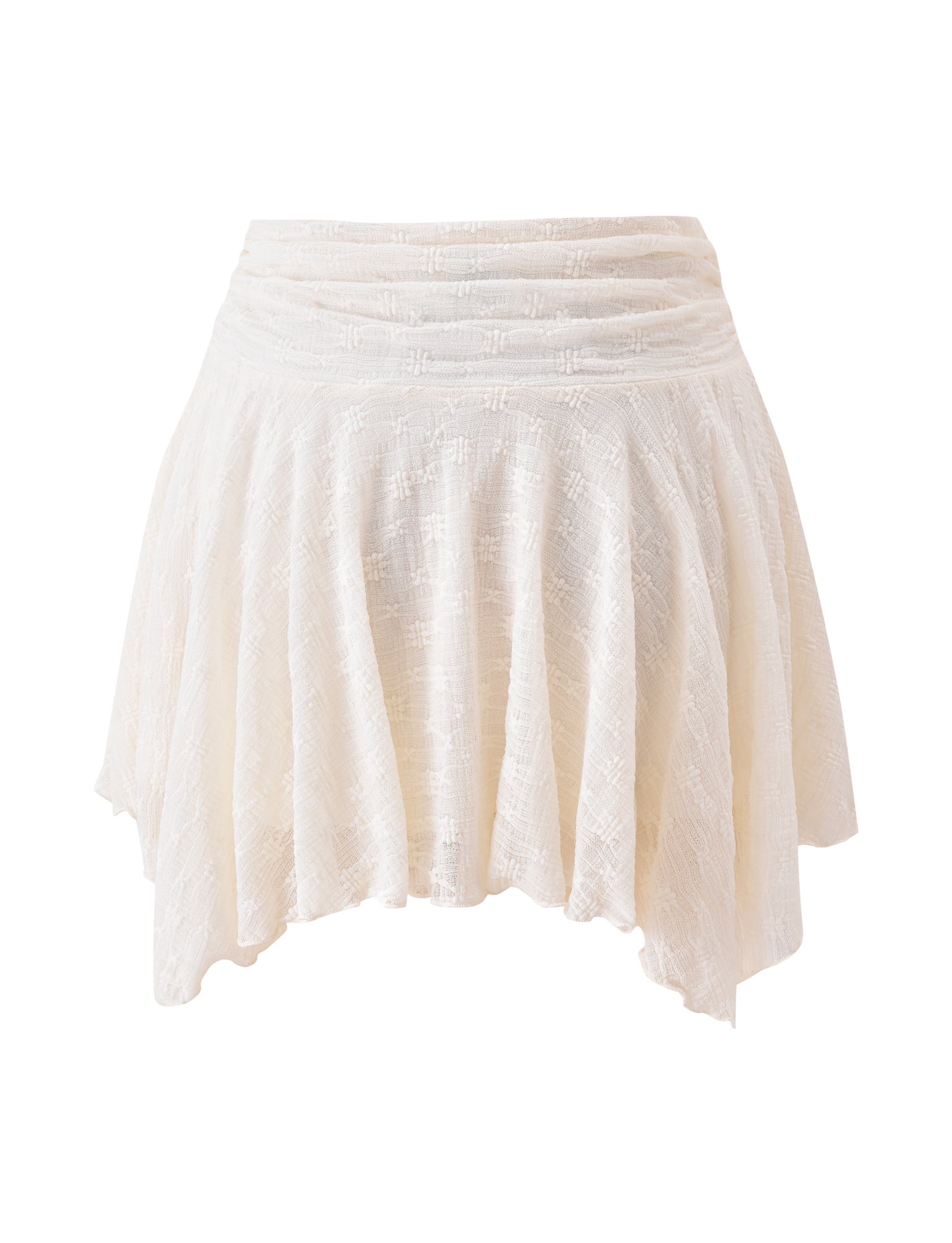 The TIGERMIST MYLAH MINI SKIRT in ivory features textured lace fabric, eyelet details, a flared handkerchief hem, and a ruched waistband, shown against a white background.