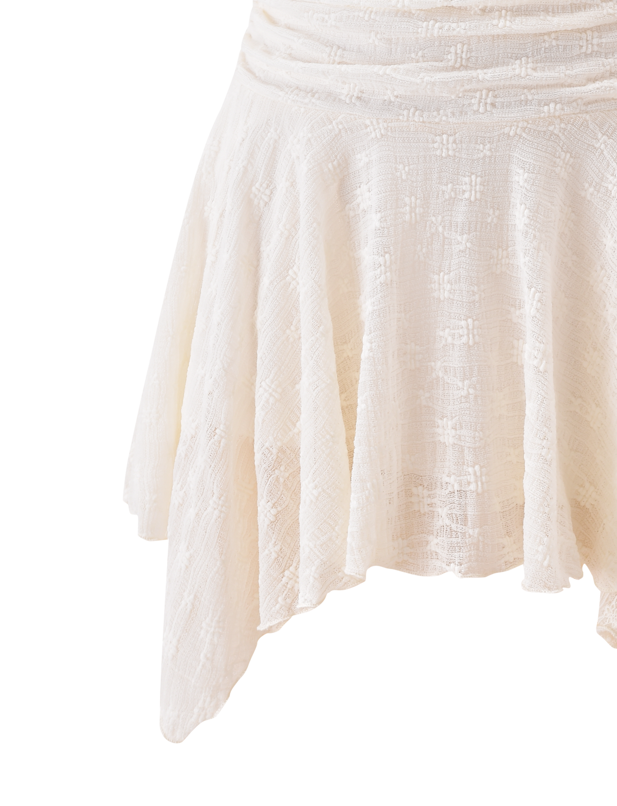 A close-up of the TIGERMIST MYLAH MINI SKIRT in ivory, showcasing its eyelet lace details, textured lightweight fabric, and handkerchief hem, set against a white background.