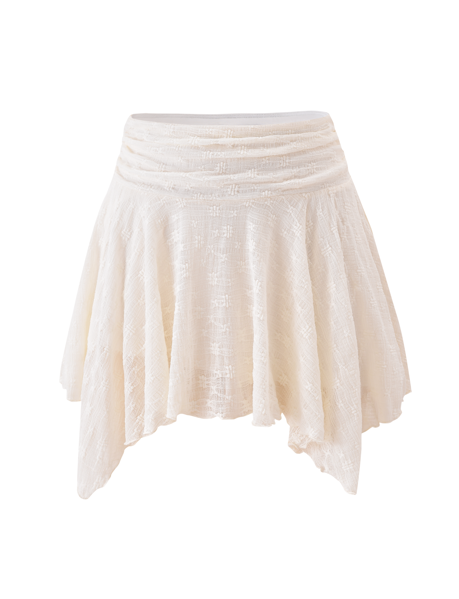 The TIGERMIST MYLAH MINI SKIRT in ivory showcases eyelet lace, a ruched waistband, and an asymmetrical handkerchief hem, displayed against a plain white background.