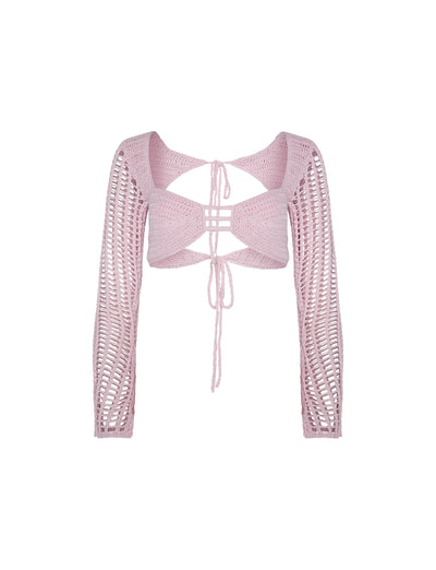 The MACAULEY TOP in Baby Pink from TIGERMIST is a cropped, long-sleeve crochet top featuring intricate open-weave patterns and multiple straps. This stylish piece boasts a tie-front design and a unique geometric back detail, creating a delicate and airy look.