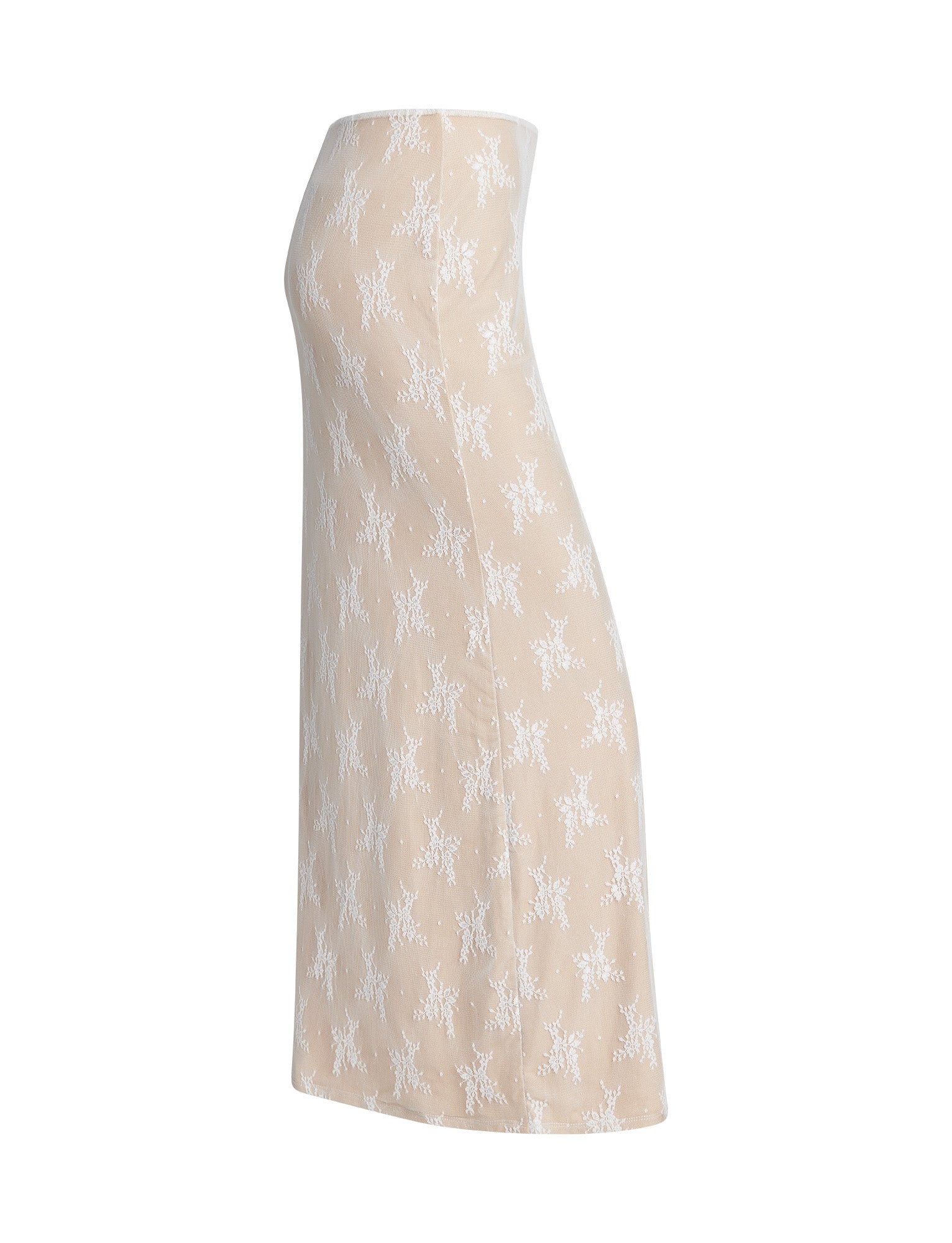 Side view of the KAROLINA SKIRT from TIGERMIST, featuring a beige, knee-length design adorned with a white floral pattern. The skirt offers a fitted silhouette with a slight flare towards the bottom and is constructed from lightweight, textured material for comfort and breathability.