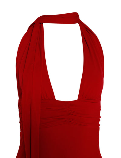 A close-up view of the LUNA DRESS - RED : FIRE ENGINE RED by TIGERMIST showcases its deep V-neckline and wide, flowing straps that elegantly drape over the shoulders and cross behind the neck. The stretchy, fitted fabric features subtle ruching below the bust. The background is plain white.