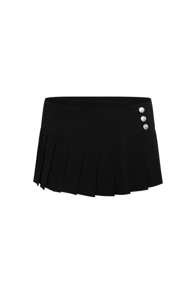 The I.AM.GIA REMINI SKORT - BLACK is a black pleated micro mini skort with a wide waistband and three silver buttons on the left side, shown on a white background.