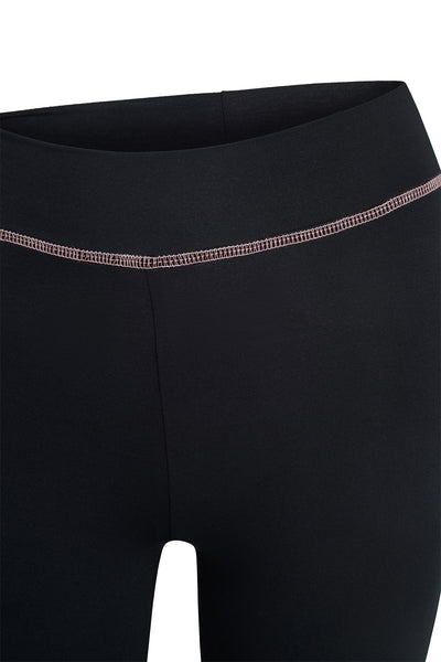 Close-up of the waistband and upper legs of the BLARE TRACKPANT - BLACK by I.AM.GIA, featuring a visible pink stitched seam across the front.