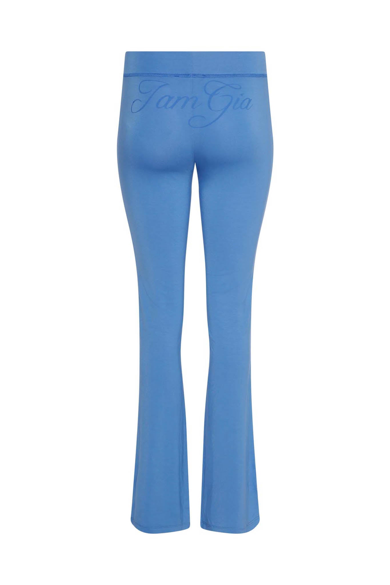 The BLARE TRACKPANT - BLUE by I.AM.GIA features a bodycon fit, flared bottoms, and the brand’s name boldly displayed across the waistband.