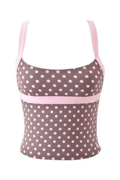 The BLARE HALTER STRAP TOP - PINK CHOCOLATE by I.AM.GIA is a sleeveless brown crop top with light pink polka dots, pink straps, and a horizontal pink band under the bust. Part of the Blare collection, shown on a white background.