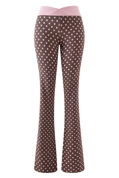 I.AM.GIA's BLARE CROSSOVER PANT - PINK CHOCOLATE features brown flared legs, playful polka dots, and a wide light pink crossover waistband, shown against a plain white background.