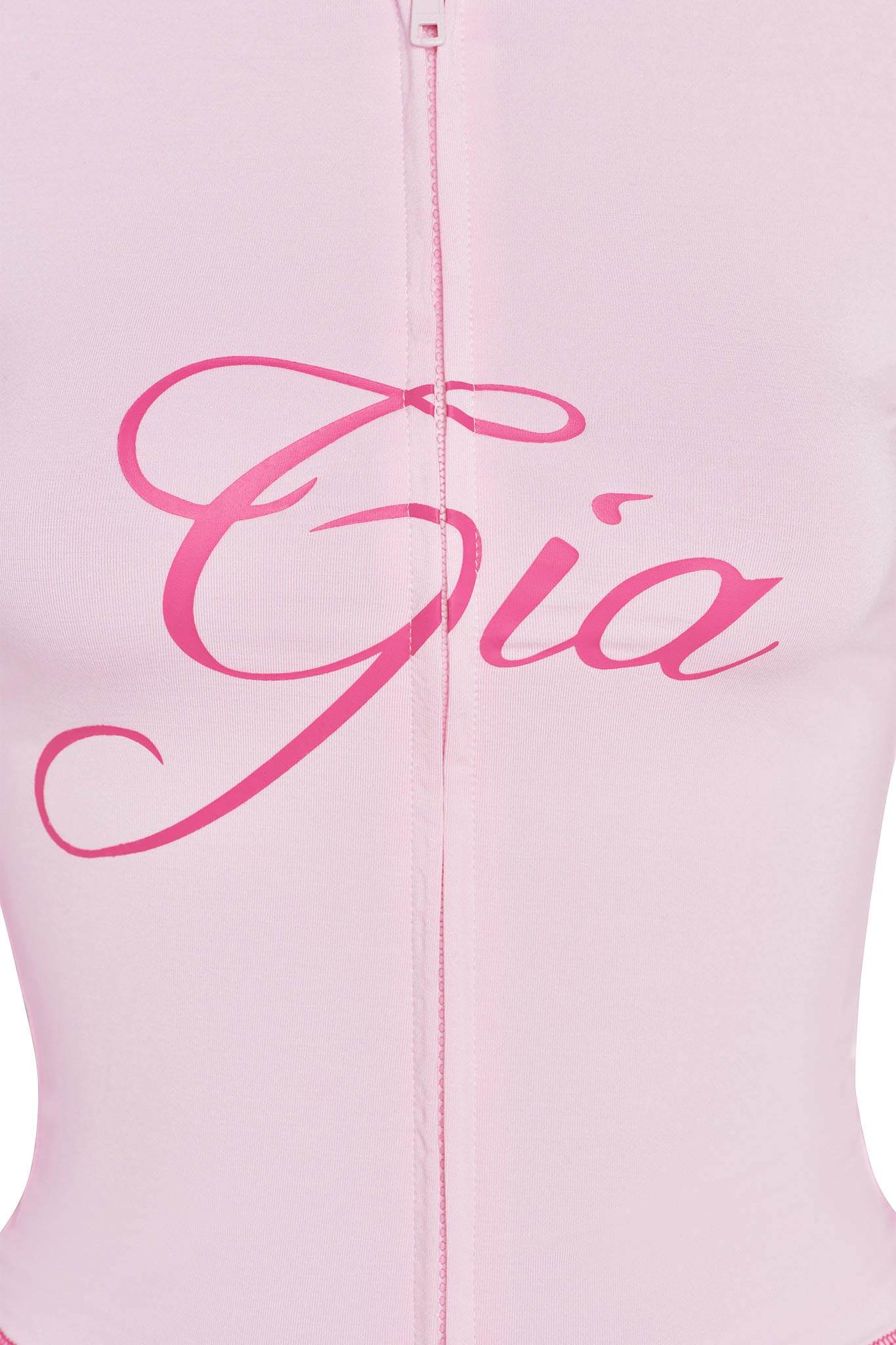Close-up of the I.AM.GIA BLARE HOODIE in pastel pink, with a zipper and "Gia" in large, bright pink cursive across the chest—a signature style from the brand.