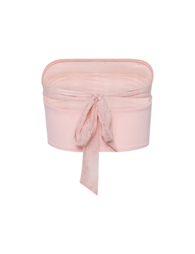 A pastel pink fabric storage box with a matching lace ribbon bow on the front and an open, box-like upper section. Designed to be decorative, this container blends practicality with an aesthetic touch, reminiscent of TIGERMIST's HARPER TOP in baby pink.