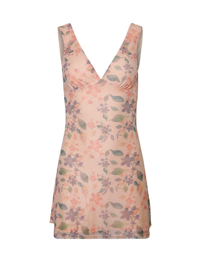 The CYRUS DRESS - ORANGE: PEACH WATERCOLOUR FLORAL by TIGERMIST is a sleeveless, V-neck dress with a light floral print pattern in shades of pink, purple, and green. It extends to mid-thigh length and has a fitted silhouette.