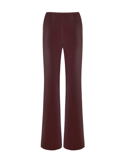 The PU TEDDIE PANT - RED in Cherry Red from TIGERMIST is a pair of high-waisted pants with a slightly flared leg. They have a smooth finish and feature a zipper closure at the front.