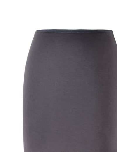 Image of the ADDISON SKIRT - GREY : STEEL GREY from the waist down to just above the knee. The fabric is smooth, and the skirt fits snugly, emphasizing a minimalist and elegant look. Designed by TIGERMIST, it exudes sophisticated style against a crisp white background.